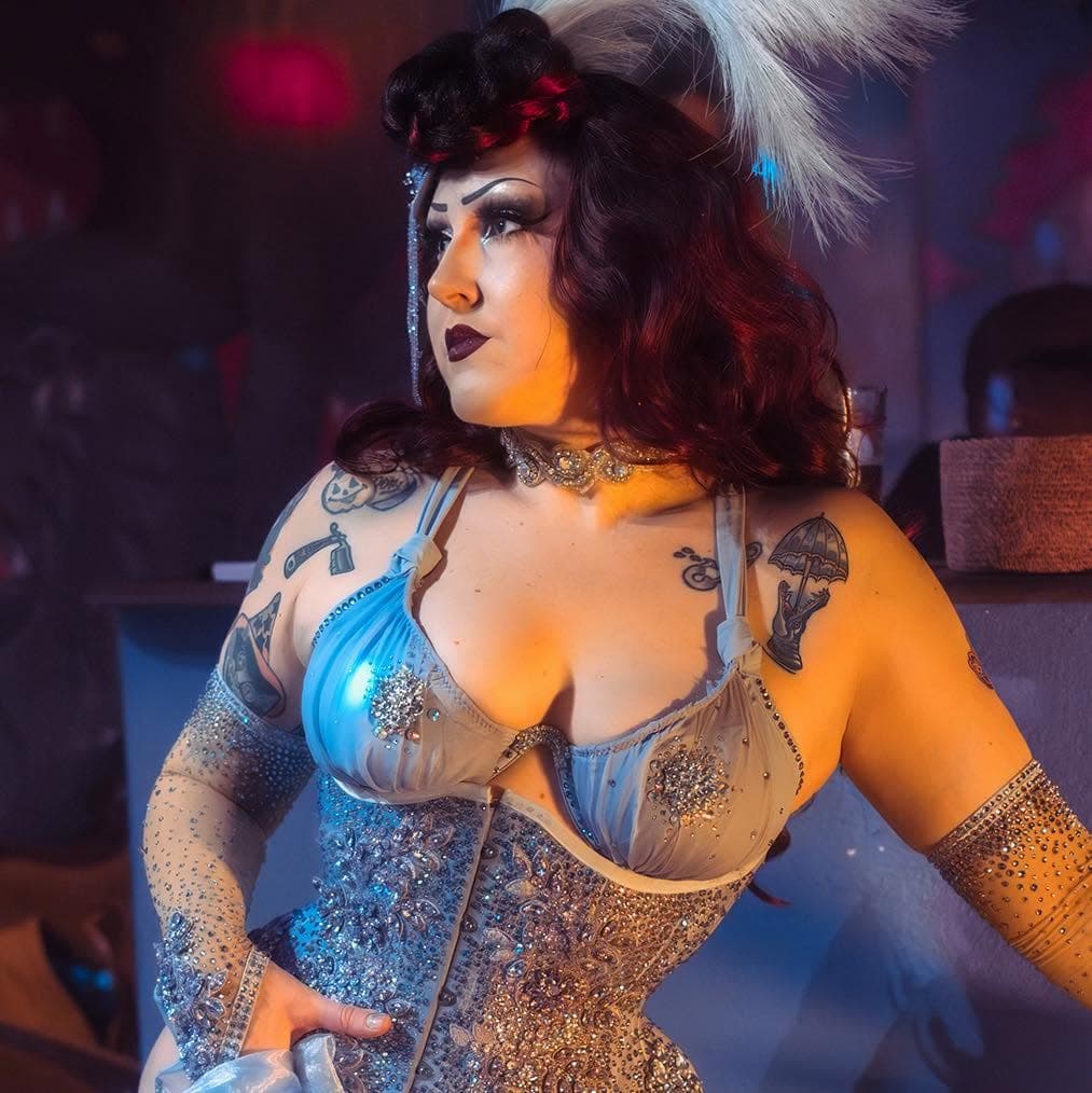 burlesque performer with curly red hair 